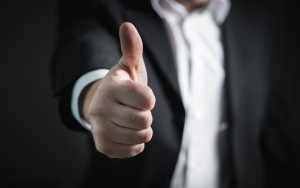 Man in suit giving the thumbs up